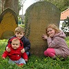 Thumbnail photo of my children with the grave of their six-greats grandparents